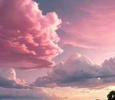 the sky is filled with pink clouds as the sun sets