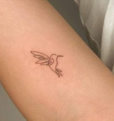 a small hummingbird tattoo on the right thigh