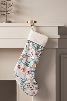 a christmas stocking hanging from a fireplace mantel