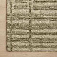 a beige rug on top of a wooden floor