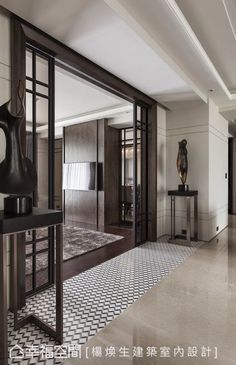 a large room with black and white tiles on the floor, two vases next to each other