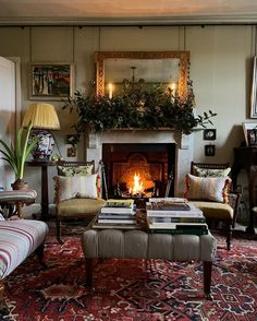 a living room filled with furniture and a fire place in the middle of the room