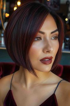 Woman with a sleek angled bob in deep burgundy tones Full Hair Color Ideas For Black Hair, Brown Bobs Haircuts, Short Burgundy Hair Bob, Bob Haircut 2024 Trends, Woman Bob Haircut, Bubble Bob Haircut 2024, Red Brown Short Hair, Dark Red Bob, Red Bob Hairstyles