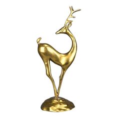 a gold statue of a deer on a white background