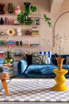 a living room filled with furniture and lots of plants on top of the shelves in front of them