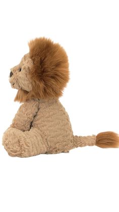 a stuffed lion sitting on the ground with it's tail curled up and eyes closed