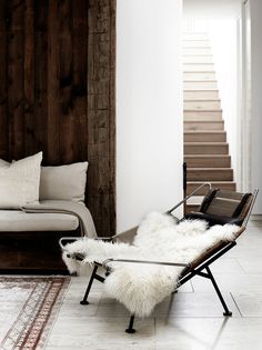 a living room filled with furniture next to a stair case