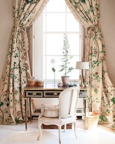 an image of a room with curtains on the window sill and a desk in front of it