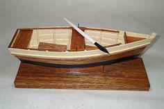 a wooden model boat with a knife in it