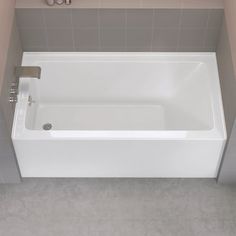 a white bath tub sitting inside of a bathroom next to a shower head faucet