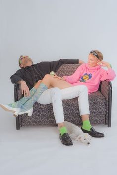 a man and woman are sitting on a couch