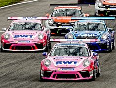 four racing cars on a race track with the number bw1 painted in pink and blue