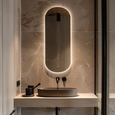 a bathroom with a sink, mirror and lights on the wall above it's counter