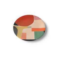 a plate with an abstract design on the front and side, painted in multicolors