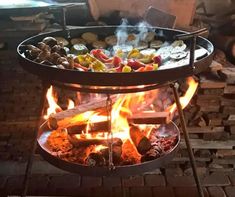 an outdoor grill with food cooking on it