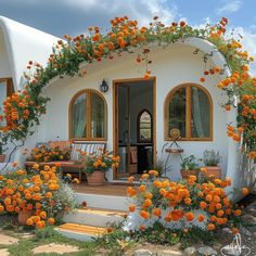 an orange and white house with lots of flowers on it