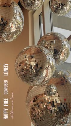 several shiny disco balls hanging from the ceiling