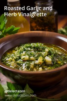 roasted garlic and herb vinaigrette in a bowl with herbs around it on a wooden table