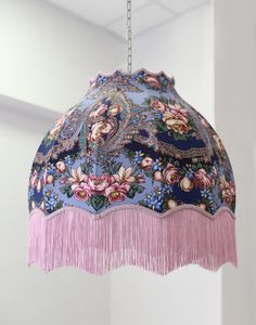 a pink and blue chandelier hanging from a ceiling