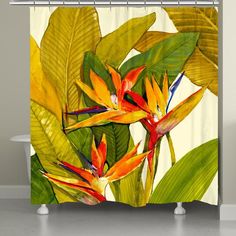 a shower curtain with tropical flowers and leaves