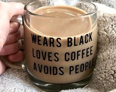 someone is holding a coffee mug that says, wears black love's coffee avoids people