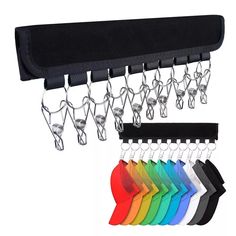 a rack with several pairs of scissors hanging from it's side and six different colors on each hanger