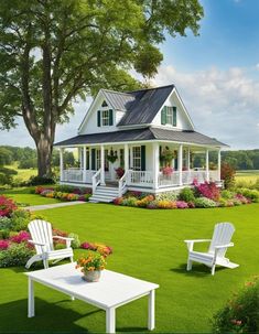 a white house sitting on top of a lush green field next to flowers and trees