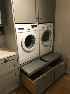 a washer and dryer are stacked on top of each other in a laundry room