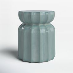 a blue vase sitting on top of a white table