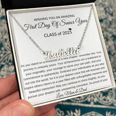 a person is holding up a necklace with the words, first day of school year