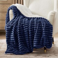 a blue blanket sitting on top of a white chair