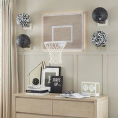 a basketball hoop hangs on the wall above a dresser