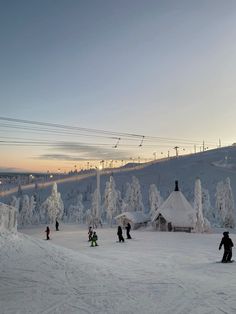 skiers and snowboarders at the bottom of a slope