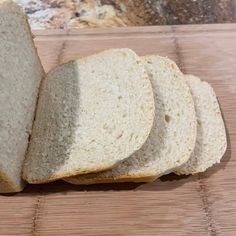 four slices of white bread sitting on top of a cutting board