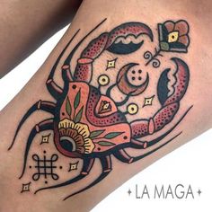 a close up of a tattoo on a person's leg with an octopus in the center