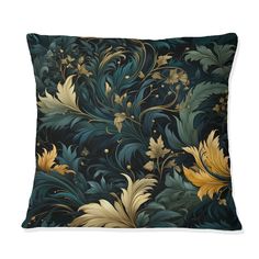 a blue and yellow pillow with an intricate design on the front, along with gold leaves