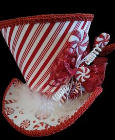 a red and white striped hat with candy canes