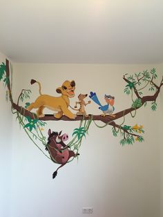 the lion king mural is on the wall in this children's room, and it looks like they are playing