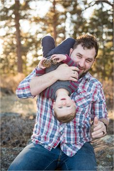 a man holding a baby in his arms