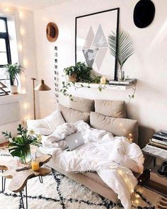 a bed with white sheets and pillows in a room next to a window, potted plants on the wall