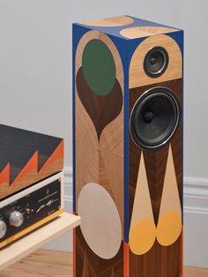 two speakers sitting next to each other on top of a wooden floor