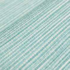 a close up view of the textured fabric on a bed sheet that is blue and white