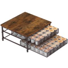 three tiered trays with coffee cups stacked on each other in front of a wooden table