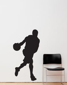 a basketball player with the ball in his hand is shown on a wall next to a chair