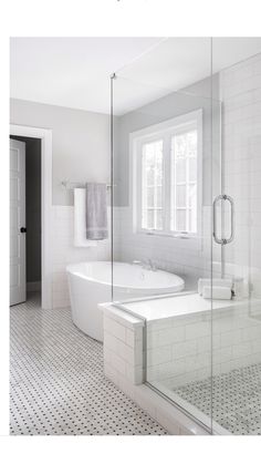 a bathroom with a tub, sink and shower stall in the middle is featured on this page