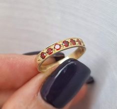 Dainty half-eternity solid gold ring set with 7 garnet gems, stacked gemstone ring jewelry for women, available in 9k yellow gold, 14k yellow, white, or rose gold, and 18k yellow gold. This delicate handmade solid gold ring is set with seven red garnet gems. It has a vintage style design, but the red and gold combination gives it a timeless style. It is available in 9k yellow gold, 14k yellow, white, or rose gold, and 18k yellow gold. This beautiful gold ring is romantic and feminine. It will lo Gem Stone Rings, Garnet Gold Ring, Beautiful Gold Rings, Dainty Gold Ring, Jewelry 2023, Garnet And Gold, Dainty Gold Rings, Solid Gold Band, Jewelry Dainty