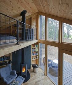 a living room filled with furniture and a fire place in front of a large window