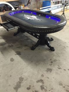 a black table with blue lights on it in a room filled with shelves and other items