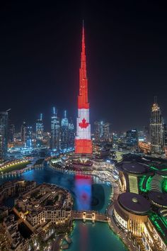 an aerial view of a city at night with the canadian flag painted on it's side