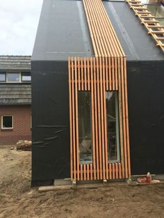 a black building with wooden slats on the side